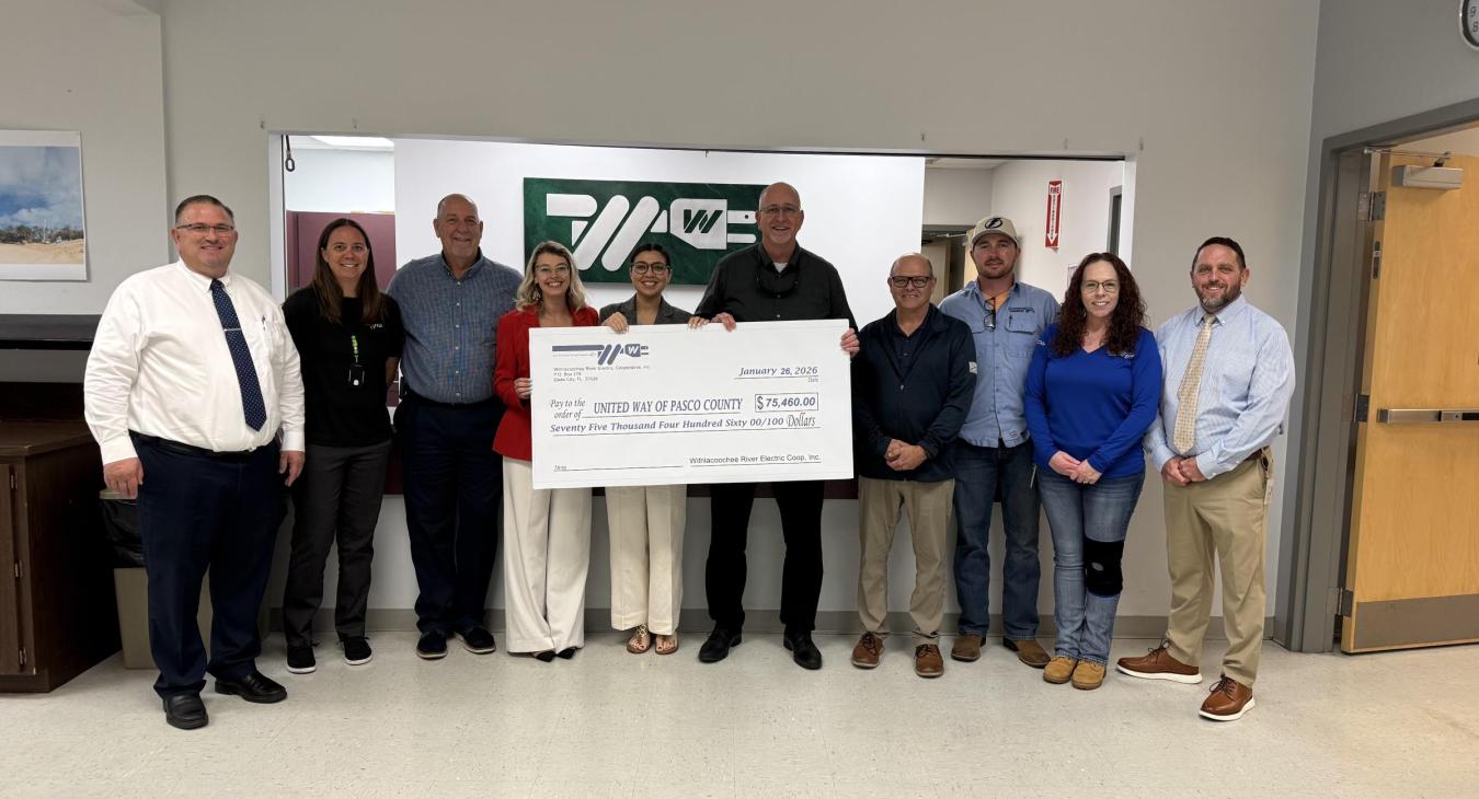 WREC presents United Way of Pasco County with a $74,460.00 donation check